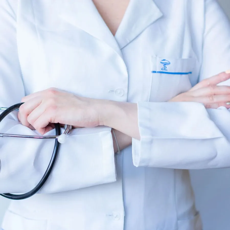 A clinician in a white coat with a stethoscope