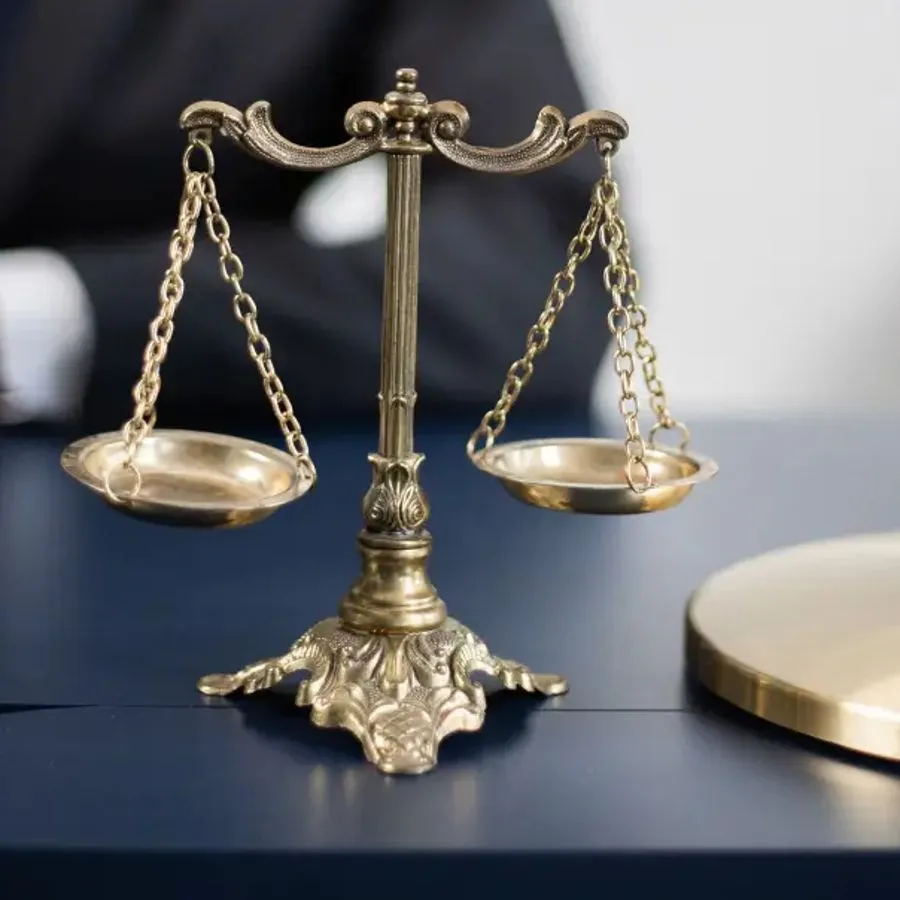 Brass scales of justice on a desk